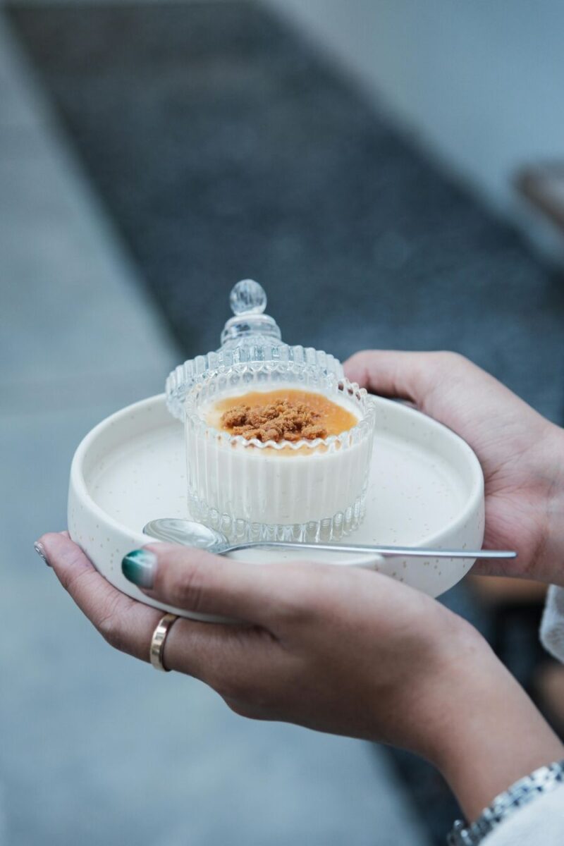 Woman holding a creme brule dessert