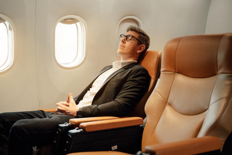 Businessman on a first class flight sleeping