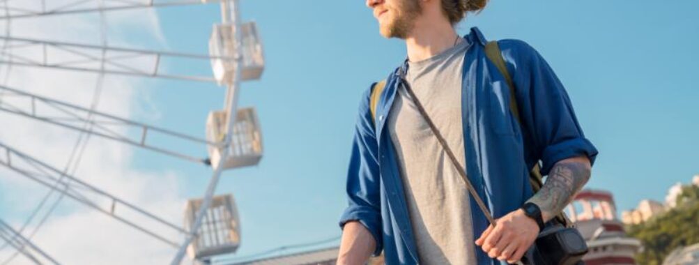 Handsome young man in casual clothing holding map