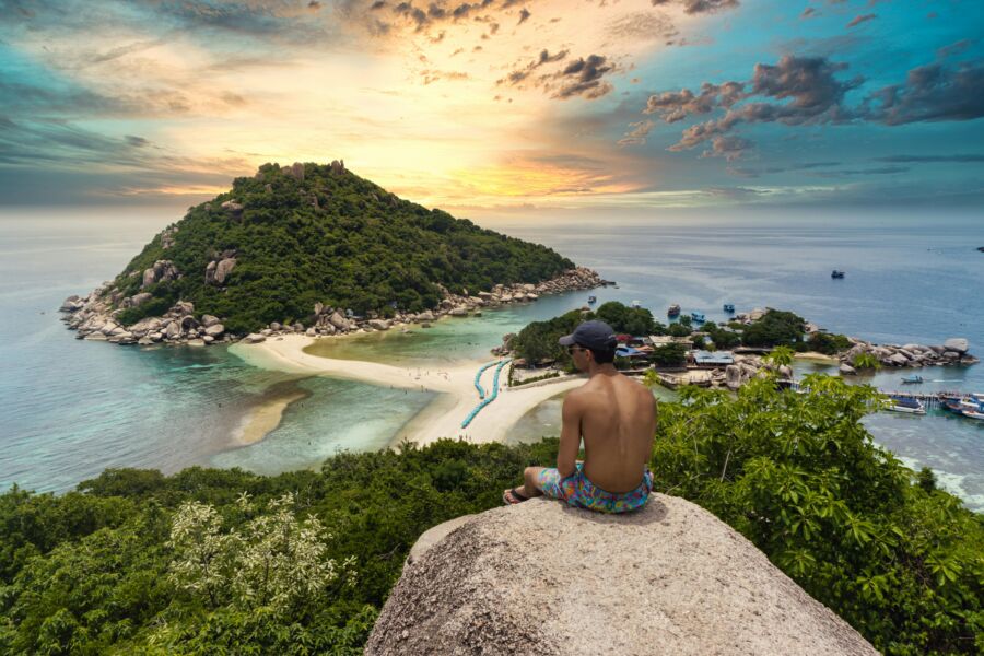 A tourist enjoying the sunset view in Koh Tao