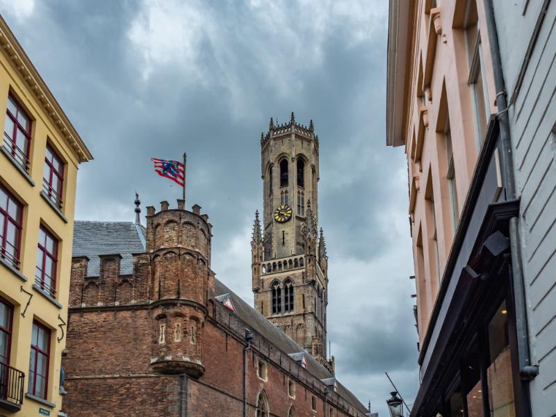 Low angle shot of Bruges flag with Belfort tower background