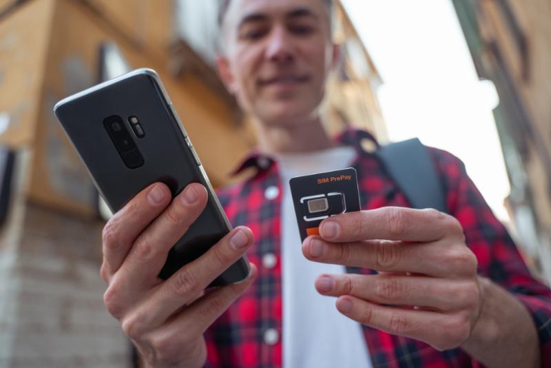 Man in red plaid shirt with a gadget in hands