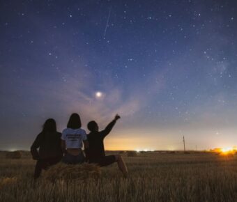 Friends stargazing outdoors