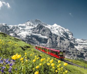 Swiss Alps with red train on a winter