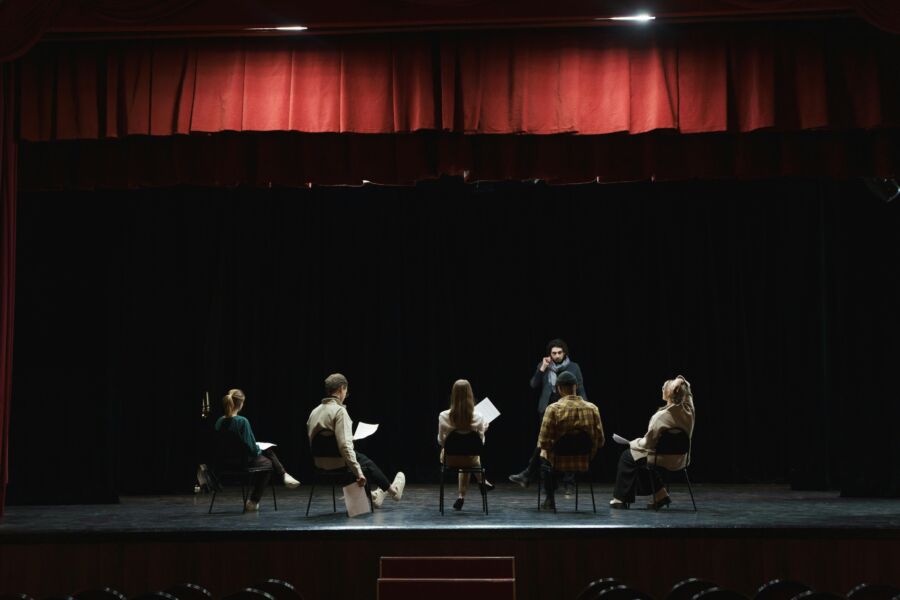 Team of actors huddling for play