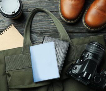 Travel essentials on wooden background