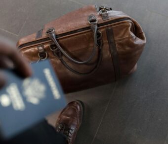 Traveler with passport and duffel bag