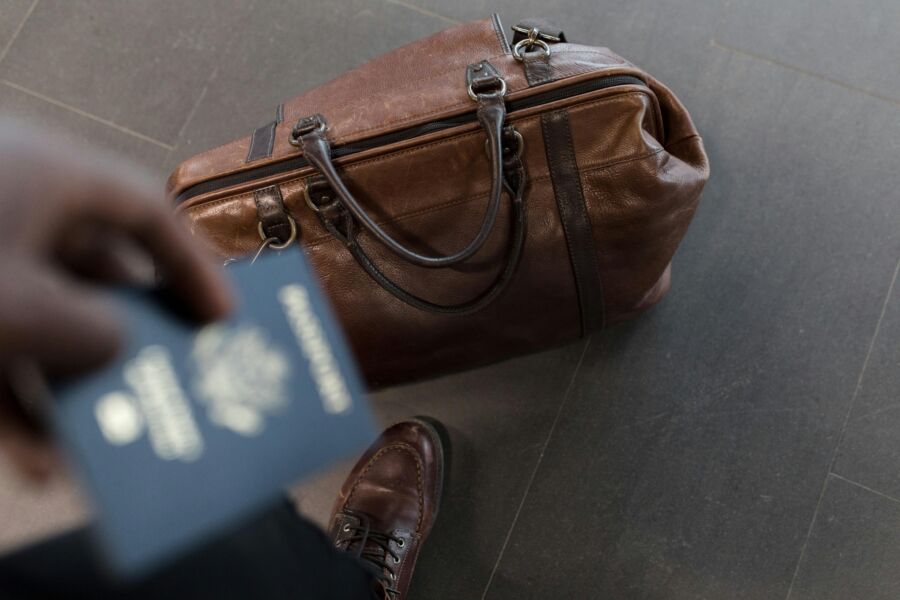 Traveler with passport and duffel bag