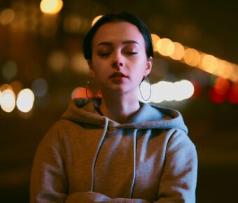 Woman in hoodie eyes closed