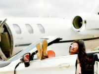 Woman jetsetter with a private jet waiting