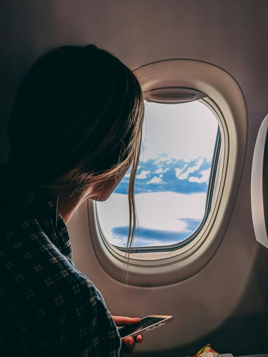 Woman on airplane window