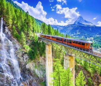 Zermatt, Switzerland. Gornergrat tourist train with waterfall