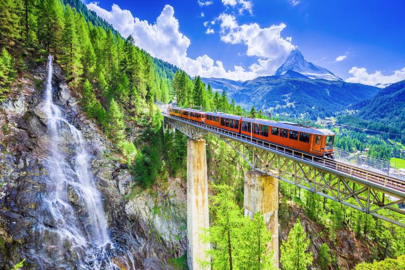 Zermatt, Switzerland. Gornergrat tourist train with waterfall