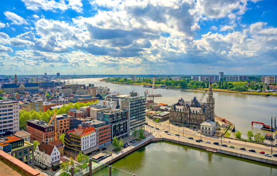 Aerial view of the bustling port and docks in Antwerp, Belgium, showcasing shipping containers and vessels in the harbor