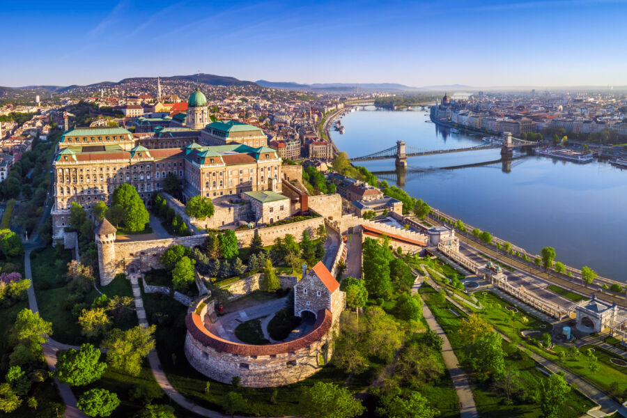 Aerial view of Budapest showcasing Buda Castle, Szechenyi Chain Bridge, Hungarian Parliament, and Matthias Church