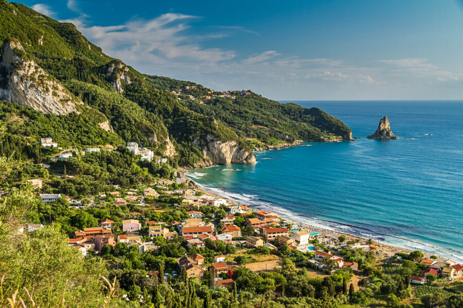 Aerial view of Agios Gordios coastline and vibrant green hills on the island of Corfu