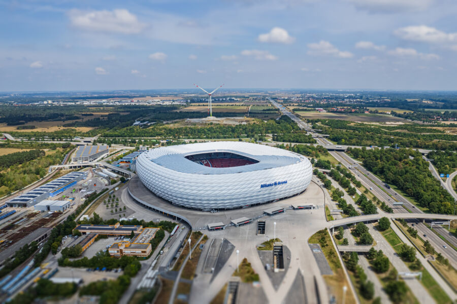 Aerial view of Allianz Arena, showcasing its unique illuminated exterior and surrounding landscape