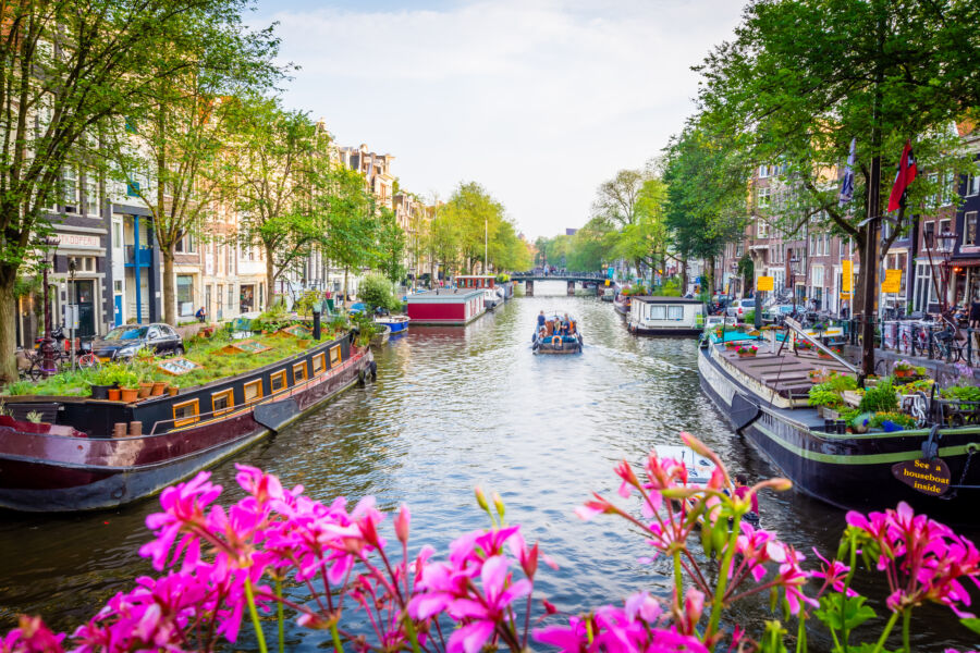 Picturesque Amsterdam canal surrounded by traditional Dutch architecture and vibrant foliage