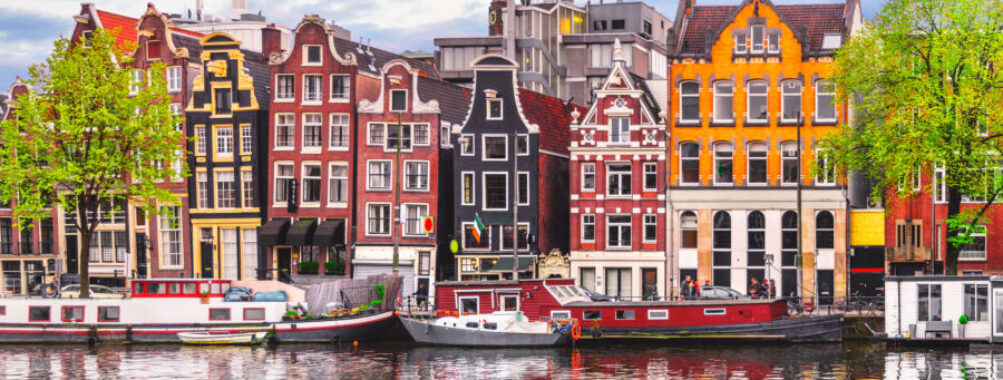 Amsterdam Netherlands dancing houses over river Amstel landmark