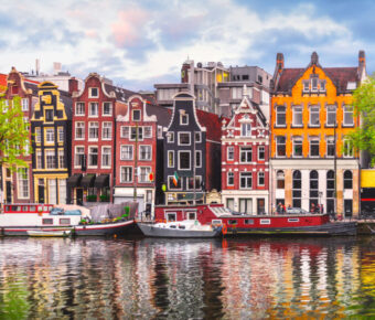 Amsterdam Netherlands dancing houses over river Amstel landmark