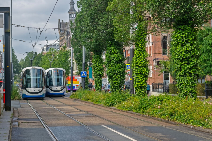 Public transport trams in Amsterdam, Netherlands, moving through the city, highlighting the efficient urban transportation network