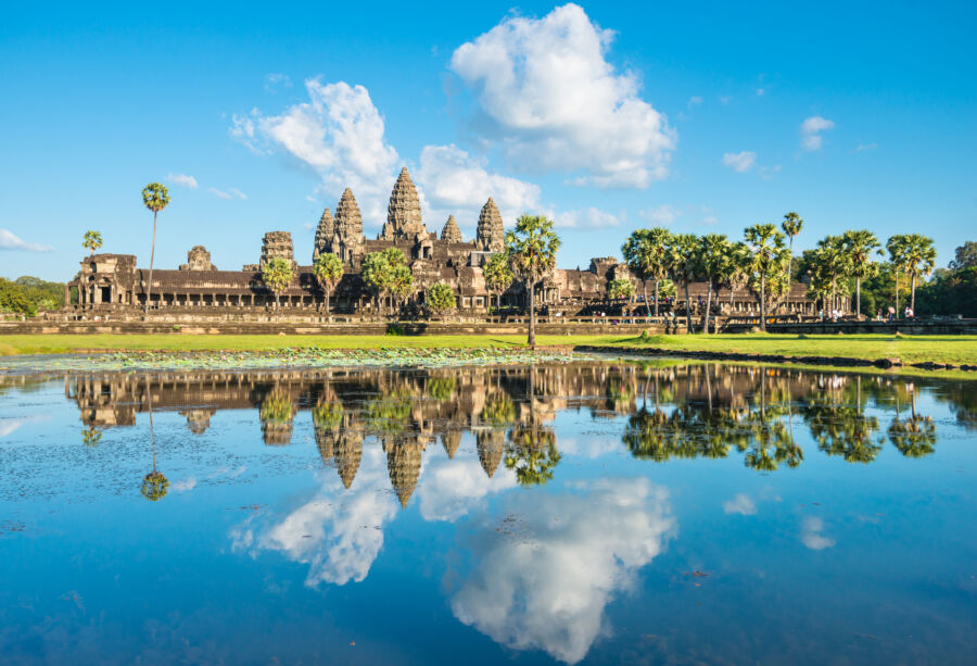 The iconic Angkor Wat temple in Cambodia, beautifully mirrored in the surrounding water, showcasing its grandeur