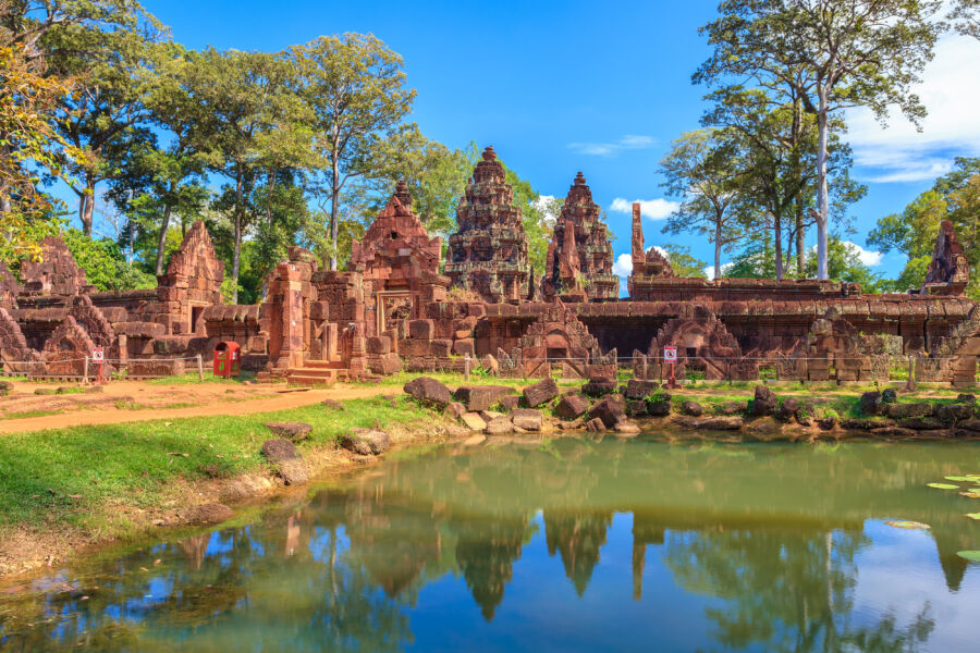 Panoramic view of Banteay Srei Temple in Siem Reap, Cambodia, showcasing intricate carvings and lush surroundings