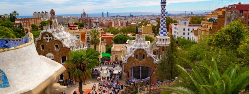 Aerial view of Park Güell in Barcelona, showcasing its colorful mosaics and unique architectural designs