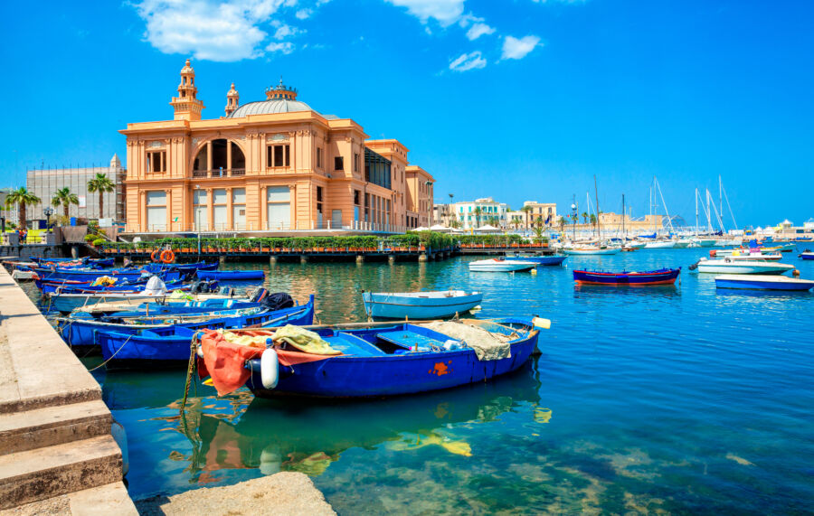 Margherita Theater and fishing boats in old harbor of Bari, Puglia, Italy. Bari is the capital city of the Metropolitan City of Bari on the Adriatic Sea, Italy. Architecture and landmark of Italy