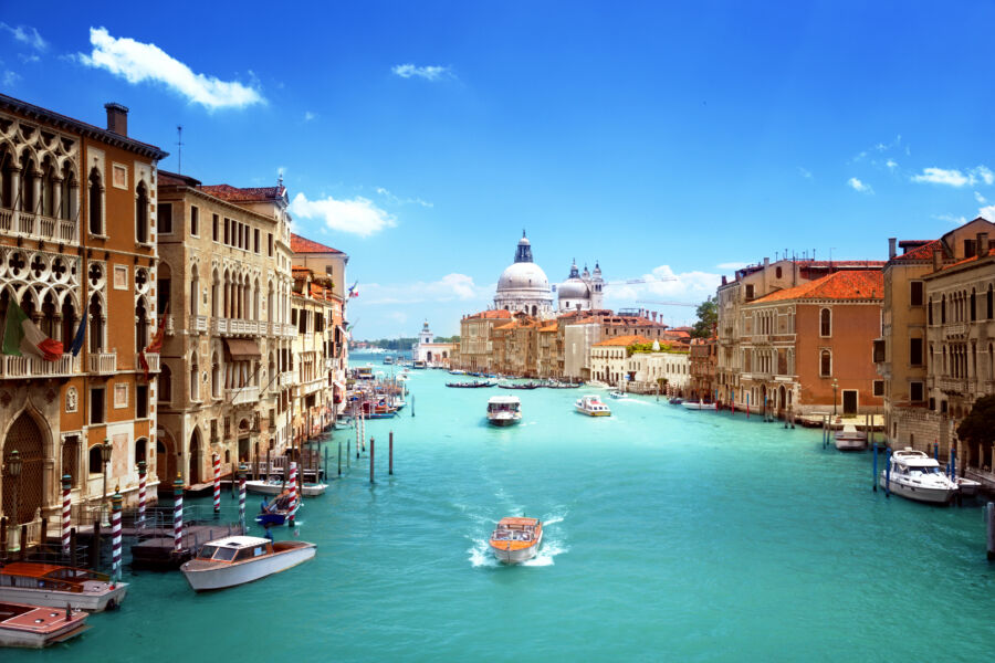 Scenic view of Basilica Santa Maria della Salute in Venice, Italy, featuring boats and a stunning skyline