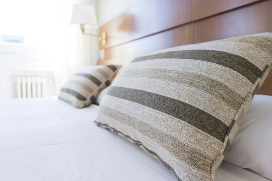 Elegant bed with striped pillows