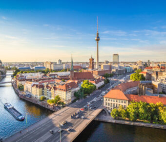 Berlin skyline panorama with TV tower and Spree river at sunset,