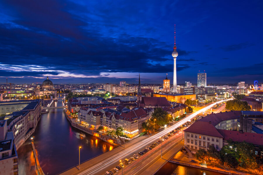 Berlin's night cityscape features glowing architecture and bustling streets