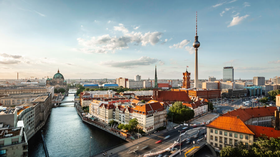 Sunset over Berlin's skyline, highlighting the iconic TV tower and the serene Spree River in a stunning panorama