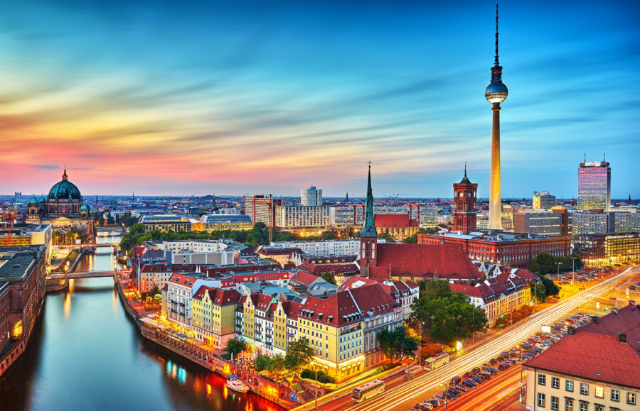 Panoramic view of Berlin's skyline at sunset, featuring the TV tower and the Spree River, showcasing the city's beauty