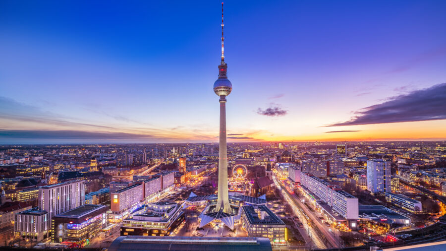 Central Berlin's panoramic sunset view, featuring the city illuminated by sparkling night lights