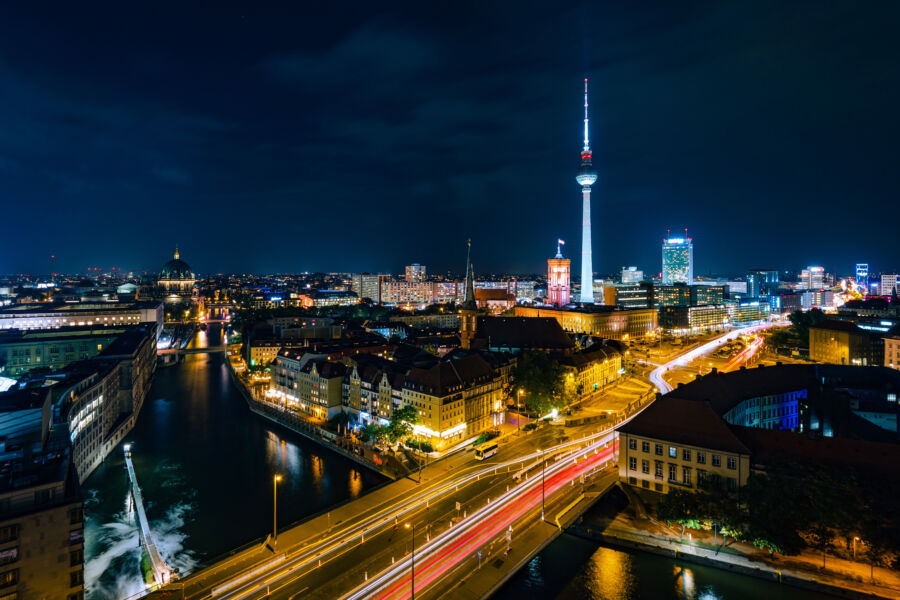 Berlin at night, featuring a stunning display of lights reflecting off historic architecture 