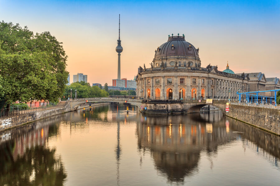 Sunrise over Berlin's skyline, featuring the Spree River and Museum Island, showcasing the city's architectural beauty