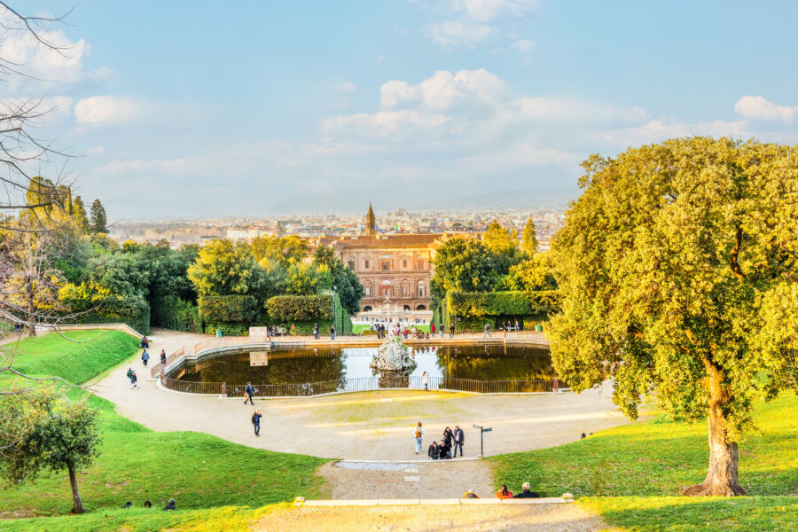 Panoramic view of Boboli Gardens in Florence, showcasing lush greenery with the historic Pitti Palace in the background