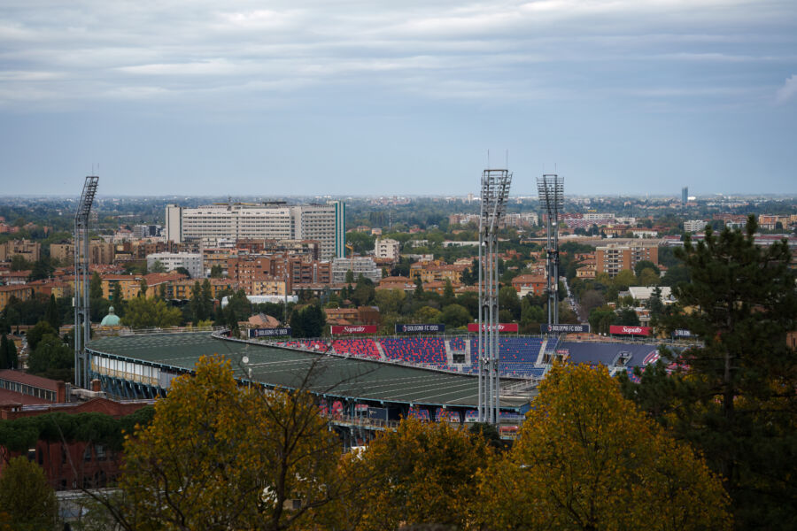 Panoramic view of Renato Dall'Ara Stadium alongside Bologna's skyline, illustrating the vibrant urban landscape