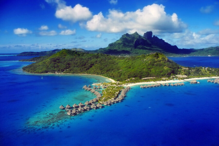 Overwater bungalows in Bora Bora, French Polynesia, surrounded by turquoise waters and lush tropical scenery