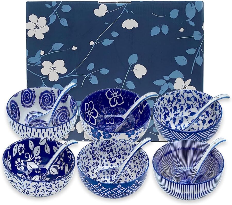 Ceramic bowls set with unique blue and white patterns against a floral blue backdrop.