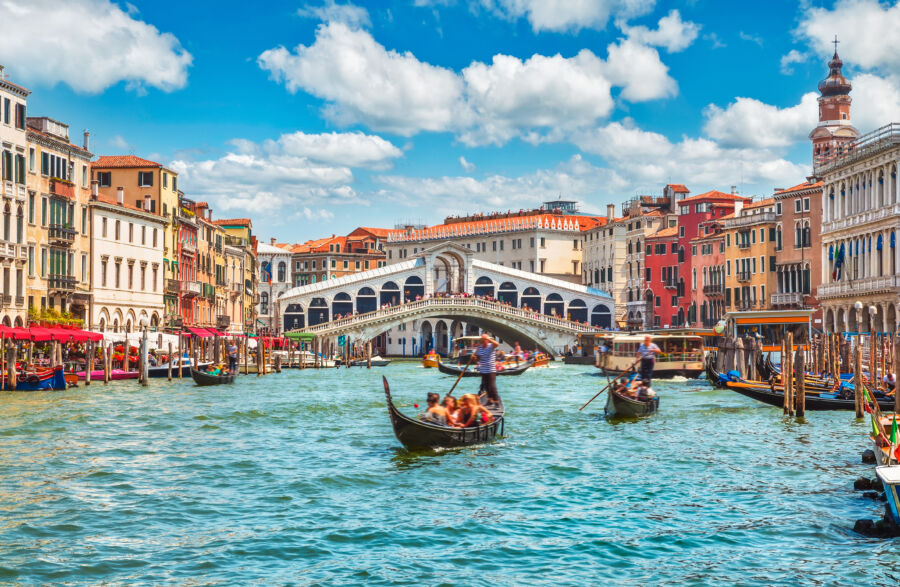 Panoramic view of the iconic Rialto Bridge spanning the Grand Canal, showcasing its architectural beauty