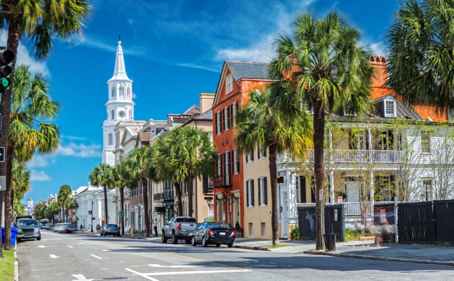 Panoramic view of St. Michaels Church with Broad Street bustling in Charleston, South Carolina, showcasing historic architecture and vibrant life 