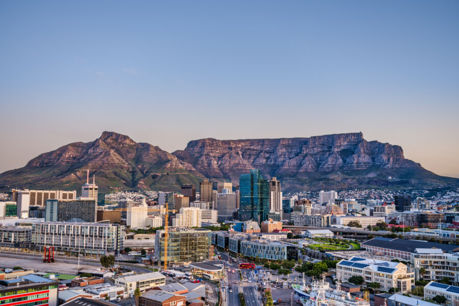 Sunset over Cape Town's central business district, with Table Mountain majestically rising in the background