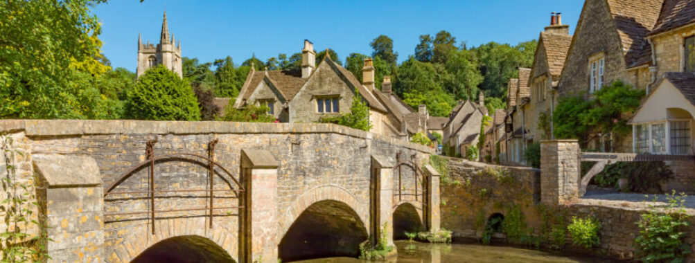 Scenic landscape of Castle Combe, featuring historic stone architecture and vibrant greenery in the heart of Wiltshire, England