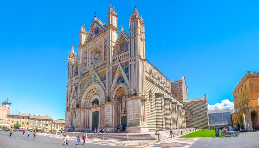 Exterior view of the Gothic Duomo di Orvieto or the Cathedral of Orvieto, showcasing its intricate architecture in Orvieto, Italy