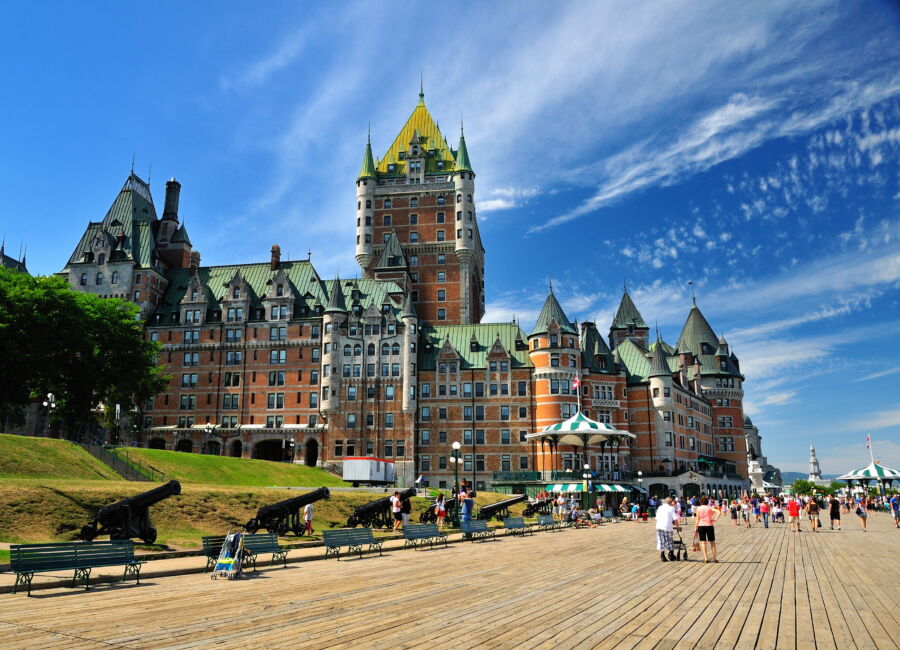 Exterior view of Chateau de Quebec in Quebec City, Canada, showcasing its stunning architecture and visitors exploring the area