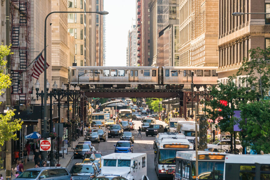 Chicago Downtown Chicago traffic with vehicles and pedestrians moving through a vibrant urban landscape