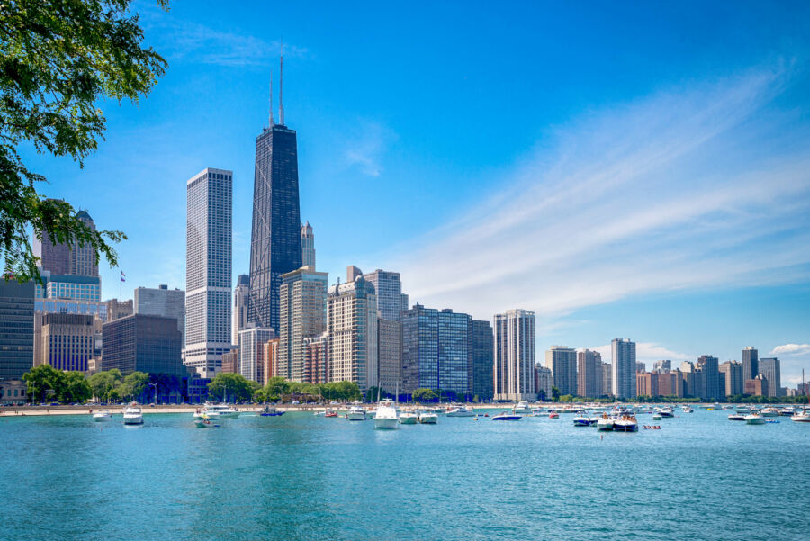 The Chicago downtown skyline showcasing a blend of historic and contemporary buildings under a bright blue sky